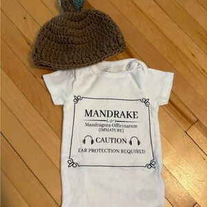 White Mandrake Baby Onesie with Brown Knit Hat